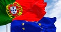 Close-up of Portugal and the European Union flags waving on a clear day