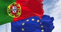 Close-up of Portugal and the European Union flags waving on a clear day