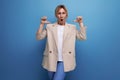 close-up of a positive hopeful blonde business woman in a jacket on the background with copy space