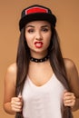 Close up positive portrait of pretty girl with amazing long brunette hair, bright sportive hat, bright make up, crazy