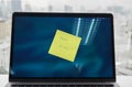 Postit of handwritten reminder to check email on notebook computer