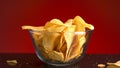 Close up of potato chips inside the transparent glass bowl. Stock footage. Crispy junk product in a small deep dish Royalty Free Stock Photo