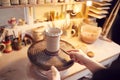 Close Up Of Potter Applying Glaze To Clay Vase In Ceramics Studio Royalty Free Stock Photo