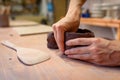 Close up of potter hands working with clay and ceramic tools, craftsman hands. knead and moistens the clay before work in ceramic Royalty Free Stock Photo