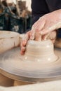 Close Up Of Potter Moulding Clay On Wheel