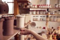 Close Up Of Potter Putting Glazed Clay Vase On Shelf In Ceramics Studio Royalty Free Stock Photo