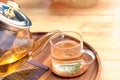 Close up Pour the tea from the kettle into a cup of tea on the table Royalty Free Stock Photo