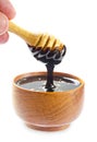 Close up pouring chocolate melt into wooden bowl Royalty Free Stock Photo