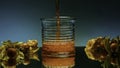 Close up of pouring fruit drink inside an empty glass. Stock clip. Bar counter decorated by small yellow berries on the Royalty Free Stock Photo