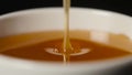 Close up of pouring honey on black background