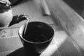 Close up pouring a hot Japanese green tea kettle on an oriental style cup on table Royalty Free Stock Photo