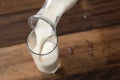 Close up - pouring milk into glass Royalty Free Stock Photo