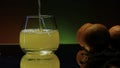 Close up of pouring orange soda into the glass. Stock clop. Soft drink with the taste of citrus and orange fruits on the