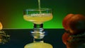 Close up of pouring orange soda into the glass. Stock clop. Soft drink with the taste of citrus and orange fruits on the