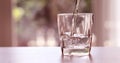 Close up pouring purified fresh drink water from the bottle on a Royalty Free Stock Photo