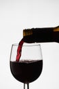 Close up of pouring of red dry wine in a crystal wine glass Royalty Free Stock Photo