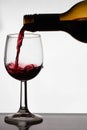 Close up of pouring of red dry wine in a crystal wine glass Royalty Free Stock Photo