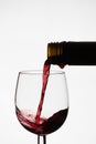 Close up of pouring of red dry wine in a crystal wine glass Royalty Free Stock Photo