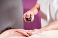 Close-up pours oil in the palm. Osteopath doing manipulative massage on female abdomen. Man hands massaging female Royalty Free Stock Photo