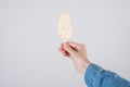 Close up pov first person cropped view photo of hand in denim clothes holding tasty yummy ice cream cover in white chocolate