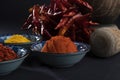 Close up on powdered red pepper in a blue bowl. Other mixed oriental food seasoning herbs blurry