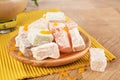 Close-up of a powdered turkish delight. Plate of fruit rahat lokum on a wooden background. Exotic confectionery sweets.