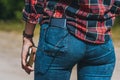 Close-up, Power Bank in the back pocket of the girl`s jeans. Against the backdrop of nature Royalty Free Stock Photo