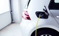 Close Up Of Power Cable Charging Environmentally Friendly Zero Emission Electric Car In Garage Royalty Free Stock Photo