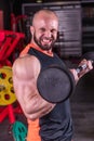 Close up of powerful muscular man doing biceps exercise with barbell at the gym Royalty Free Stock Photo