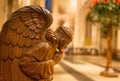 Close Up of a Praying Wooden Angel inside Norwich Cathedral