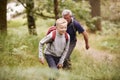 Close up of pre-teen boy hiking with his grandfather in a forest, selective focus Royalty Free Stock Photo