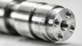 Close-up of a precision-engineered metallic cylindrical component with threaded holes, showcasing detailed machining work often Royalty Free Stock Photo