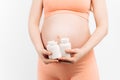 Pregnant belly with medicine on a white background. A woman is expecting a baby, with pills Royalty Free Stock Photo