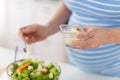 Close up of pregnant woman cooking salad at home Royalty Free Stock Photo