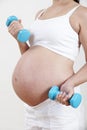 Close Up Of Pregnant Woman Exercising With Weights Royalty Free Stock Photo