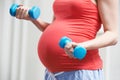 Close Up Of Pregnant Woman Exercising With Weights Royalty Free Stock Photo