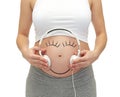 Close up of pregnant woman and headphones on tummy Royalty Free Stock Photo