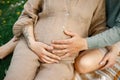 Close up of pregnant woman and her handsome hugging the belly