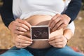 Close up of pregnant woman and her husband holding ultrasound sc Royalty Free Stock Photo