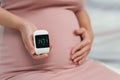 Pregnant woman holding glucose meter with result of measurement sugar high level. gestational diabetes concept