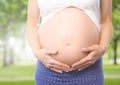 Close-up of pregnant woman holding her belly