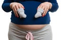 Close-up of pregnant woman holding pair of baby socks