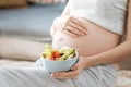 Close up of pregnant woman holding a salad