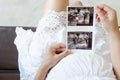Close up of pregnant woman holding ultrasound scan Royalty Free Stock Photo