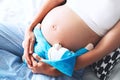 Close-up pregnant woman`s belly with teddy toy bear. Royalty Free Stock Photo