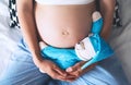 Close-up pregnant woman`s belly with teddy toy bear. Royalty Free Stock Photo