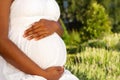 Young African American pregnant woman holding her stomach.