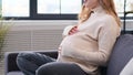 Close Up Of A Pregnant Woman Stroking Belly At Home