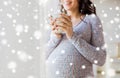 Close up of pregnant woman with tea cup at window Royalty Free Stock Photo