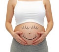 Close up of pregnant woman touching her bare tummy Royalty Free Stock Photo